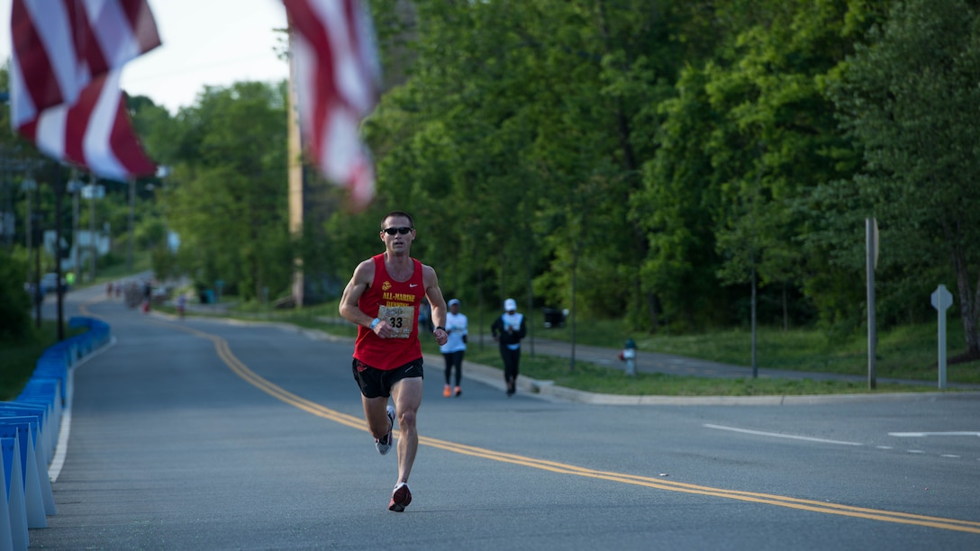 Capt. Calum Ramm a Marine Corps intelligence officer for the Marine Corps Cyber Space Warfare Group at Fort George G. Meade, Maryland, runs through the Blue Mile at the Marine Corps Historic Half Marathon in Fredericksburg, Virginia, May 15, 2016. Ramm finished third in the race despite recovering from several injuries and after completing seven marathons in seven continents in seven days. 