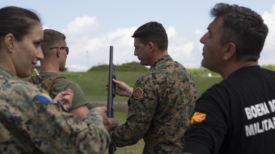 Sgt. Maj. Sasha Toshevski, first sergeant of the Macedonian Special Forces Regiment, instructs a Bosnian solider on shotgun firing techniques while training in a non-lethal weapons class during exercise Platinum Wolf 2016 at Peacekeeping Operations Training  Center South Base in Bujanovac, Serbia, May 13, 2016. Seven countries including Bosnia, Bulgaria, Macedonia, Montenegro, Slovenia, Serbia, and the United States joined together to enhance their ability to work together and master the use on non-lethal weapons systems. 