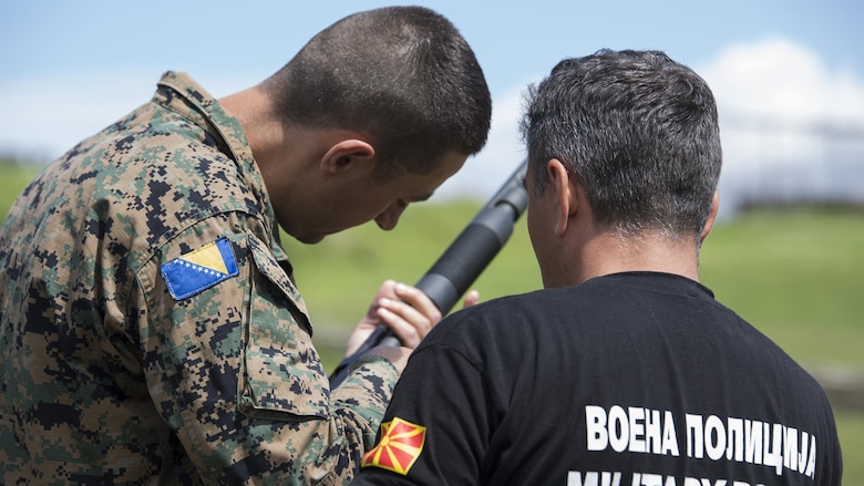Sgt. Maj. Sasha Toshevski, first sergeant and non-lethal weapons instructor with the Macedonian Special Forces Regiment, instructs a Bosnian soldier on shotgun loading techniques while training in a non-lethal weapons class, during exercise Platinum Wolf 2016 at Peacekeeping Operations Training  Center South Base in Bujanovac, Serbia, May 13, 2016. Seven countries including Bosnia, Bulgaria, Macedonia, Montenegro, Slovenia, Serbia, and the United States joined together to enhance their ability to work together and master the use on non-lethal weapons systems. 