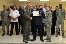 Michael Reyes, 47th Maintenance Directorate aircrew egress systems craftsman, accepts the “XLer of the Week” award from Col. Thomas Shank, left, 47th Flying Training Wing commander, and Chief Master Sgt. Teresa Clapper, right, 47th FTW command chief, here, May 11, 2016. The XLer is a weekly award chosen by wing leadership and is presented to those who consistently make outstanding contributions to their unit and Laughlin. (U.S. Air Force photo/Airman 1st Class Brandon May)
