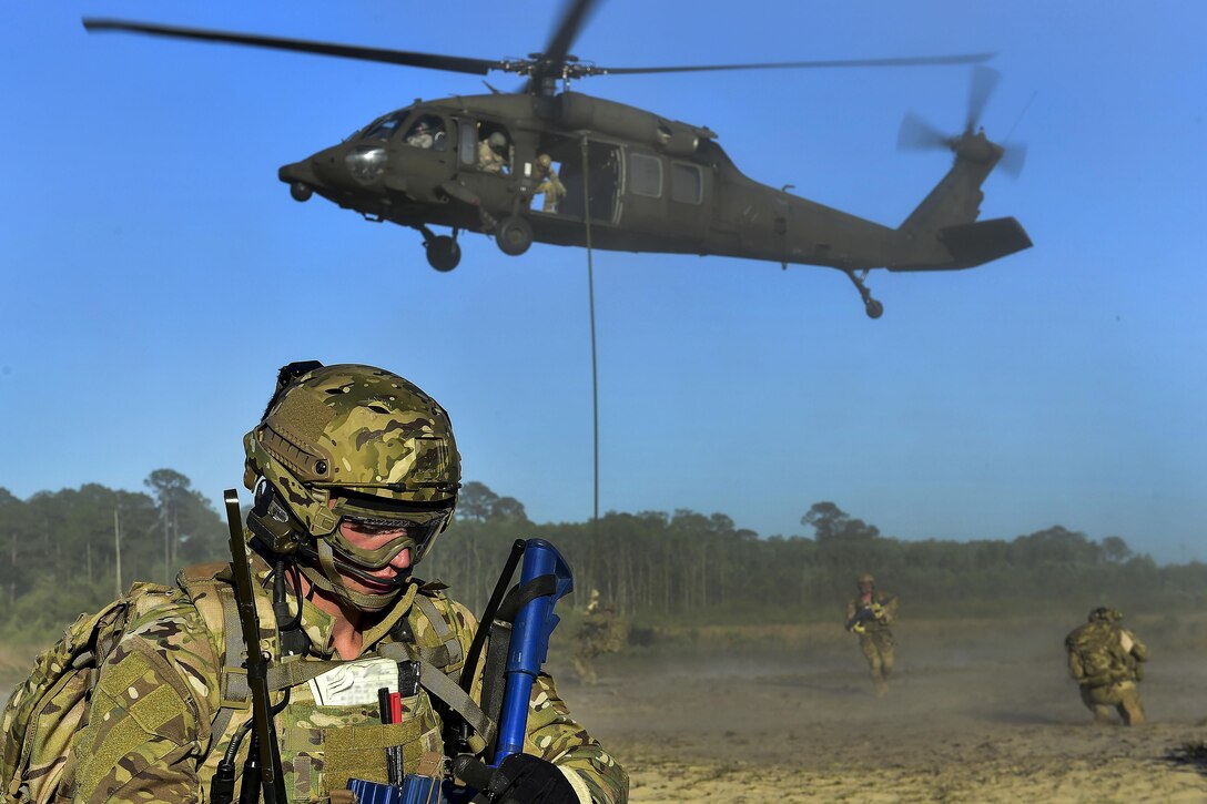 Airmen secure the perimeter after participating in fast-rope training from an Army UH-60 Black Hawk during Emerald Warrior at Hurlburt Field, Fla., May 4, 2016. Air Force photo by Senior Airman Jeff Parkinson