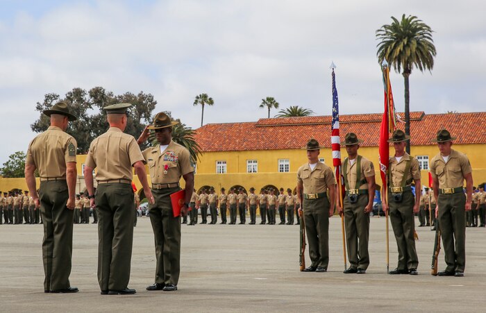 Sergeant Maj. James K. Porterfield salutes Brig. Gen. James W. Bierman, Commanding General, Marine Corps Recruit Depot San Diego/Western Recruiting Region, after receiving the Legion of Merit (gold star in lieu of second award) during a post and relief ceremony at MCRD San Diego, April 29. Porterfield was relieved by Sgt. Maj. Alex M. Dobson, Sergeant Major of MCRD San Diego/WRR, after serving at the depot since October 2013.