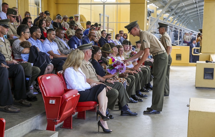 Flowers are presented to the loved ones of Sgt. Maj. Alex M. Dobson, Sergeant Major of Marine Corps Recruit Depot San Diego/Western Recruiting Region, and Sgt. Maj. James K. Porterfield during a post and relief ceremony at MCRD San Diego, April 29. Porterfield was relieved by Dobson after serving at the depot since October 2013.