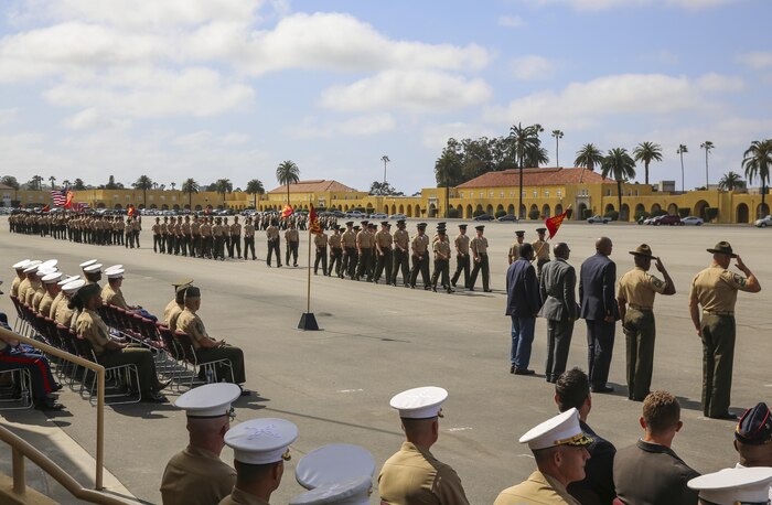 Sergeant Maj. Alex M. Dobson, Sergeant Major of Marine Corps Recruit Depot San Diego/Western Recruiting Region, and Sgt. Maj. James K. Porterfield stand with fellow retired sergeants major during a post and relief ceremony at MCRD San Diego, April 29. To conclude the ceremony, Marines from the WRR participated in a Pass in Review before marching off of the parade deck.
