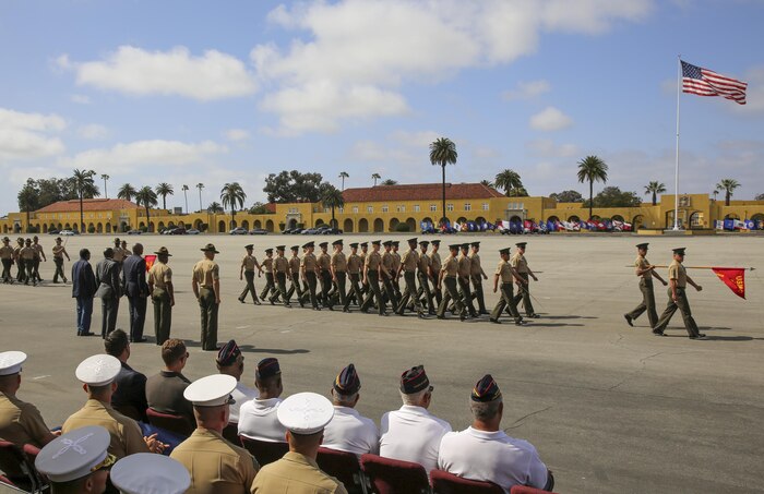 Sergeant Maj. Alex M. Dobson, Sergeant Major of Marine Corps Recruit Depot San Diego/Western Recruiting Region, and Sgt. Maj. James K. Porterfield stand with fellow retired sergeants major during a post and relief ceremony at MCRD San Diego, April 29. To conclude the ceremony, Marines from the WRR participated in a Pass in Review before marching off of the parade deck.
