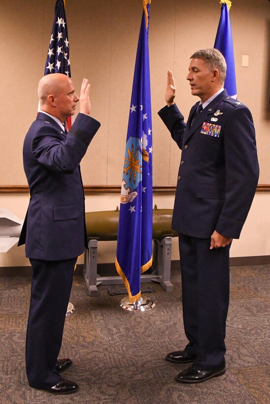 U.S. Air Force Brig. Gen. Jon Ellis, the mobilization assistant to the Director of Operations at Headquarters Global Strike Command, administers the oath of office to Col. Robert VanHoy during a promotion ceremony at Barksdale Air Force Base, La. on May 15, 2016. VanHoy is the commander of the 93rd Bomb Squadron as well as a command pilot with over 4,000 flight hours. (U.S. Air Force photo by Master Sgt. Dachelle Melville/Released)