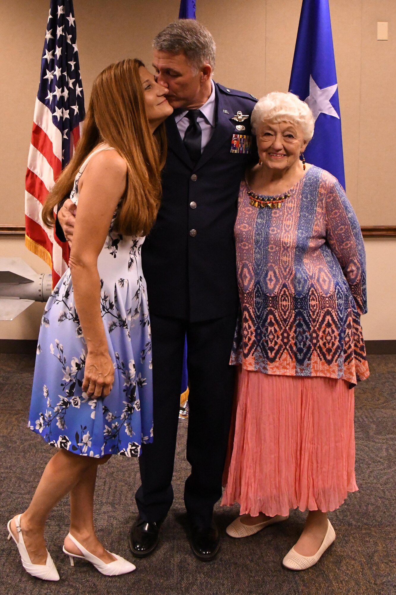 U.S. Air Force Col. Robert VanHoy kisses his wife Tess and hugs his mother Helen after being “pinned” with the rank of colonel during his promotion ceremony at Barksdale Air Force Base, La. on May 15, 2016. VanHoy is the commander of the 93rd Bomb Squadron and was recently promoted to the rank of colonel. (U.S. Air Force photo by Master Sgt. Dachelle Melville/Released)