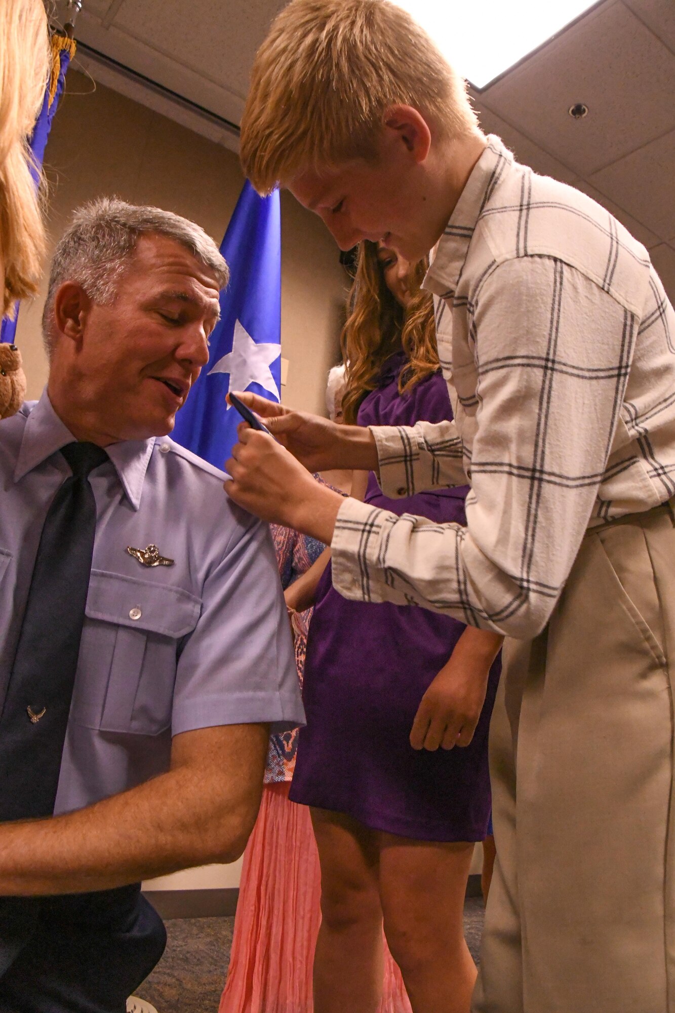 U.S. Air Force Col. Robert VanHoy, the 93rd Bomb Squadron commander, is “pinned” by his son during a promotion ceremony at Barksdale Air Force Base, La. on May 15, 2016. VanHoy is a command pilot with over 4,000 flight hours and was recently promoted to the rank of colonel. (U.S. Air Force photo by Master Sgt. Dachelle Melville/Released)