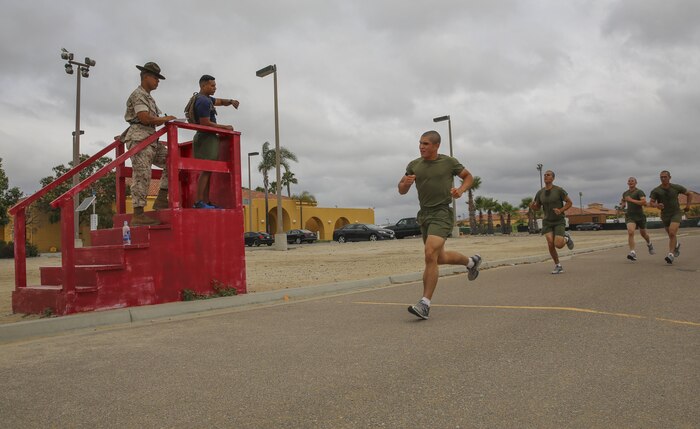 Recruits of Lima Company, 3rd Recruit Training Battalion, finish a three-mile run during an inventory physical fitness test at Marine Corps Recruit Depot San Diego, May 16. The run was the second portion of the event, after the pull-ups and before conducting crunches. Annually, more than 17,000 males recruited from the Western Recruiting Region are trained at MCRD San Diego. Lima Company is scheduled to graduate June 10.