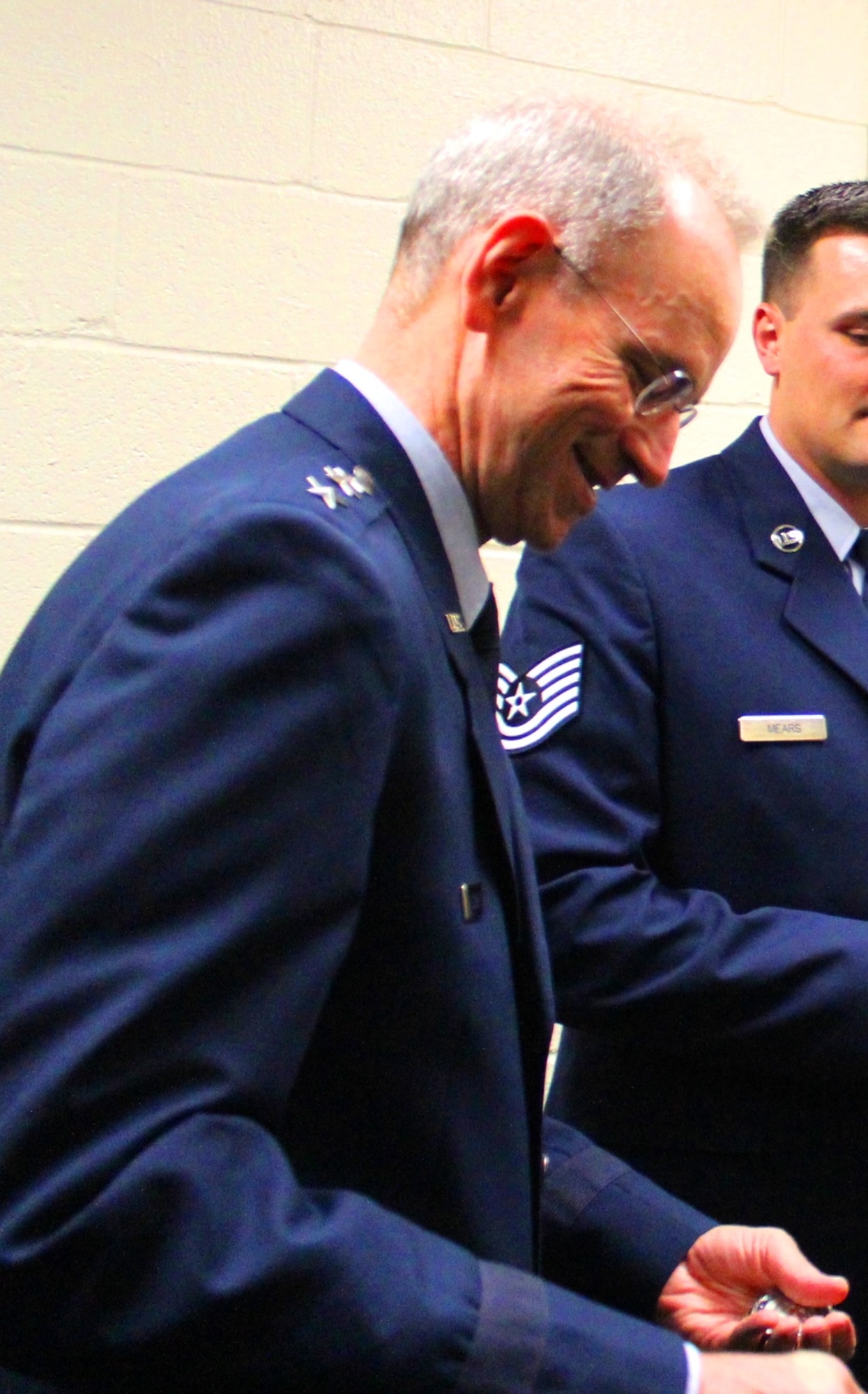 Air Force Surgeon General Lt. Gen. (Dr.) Mark Ediger prepares to present all five Air Force EMDP2 charter class students with the AF Surgeon General’s coin. Students met with Gen. Ediger backstage, prior to the start of the commencement ceremony, held at George Mason University on May 11, 2016. (U.S. Air Force photo by Prerana Korpe, AFMS Public Affairs)