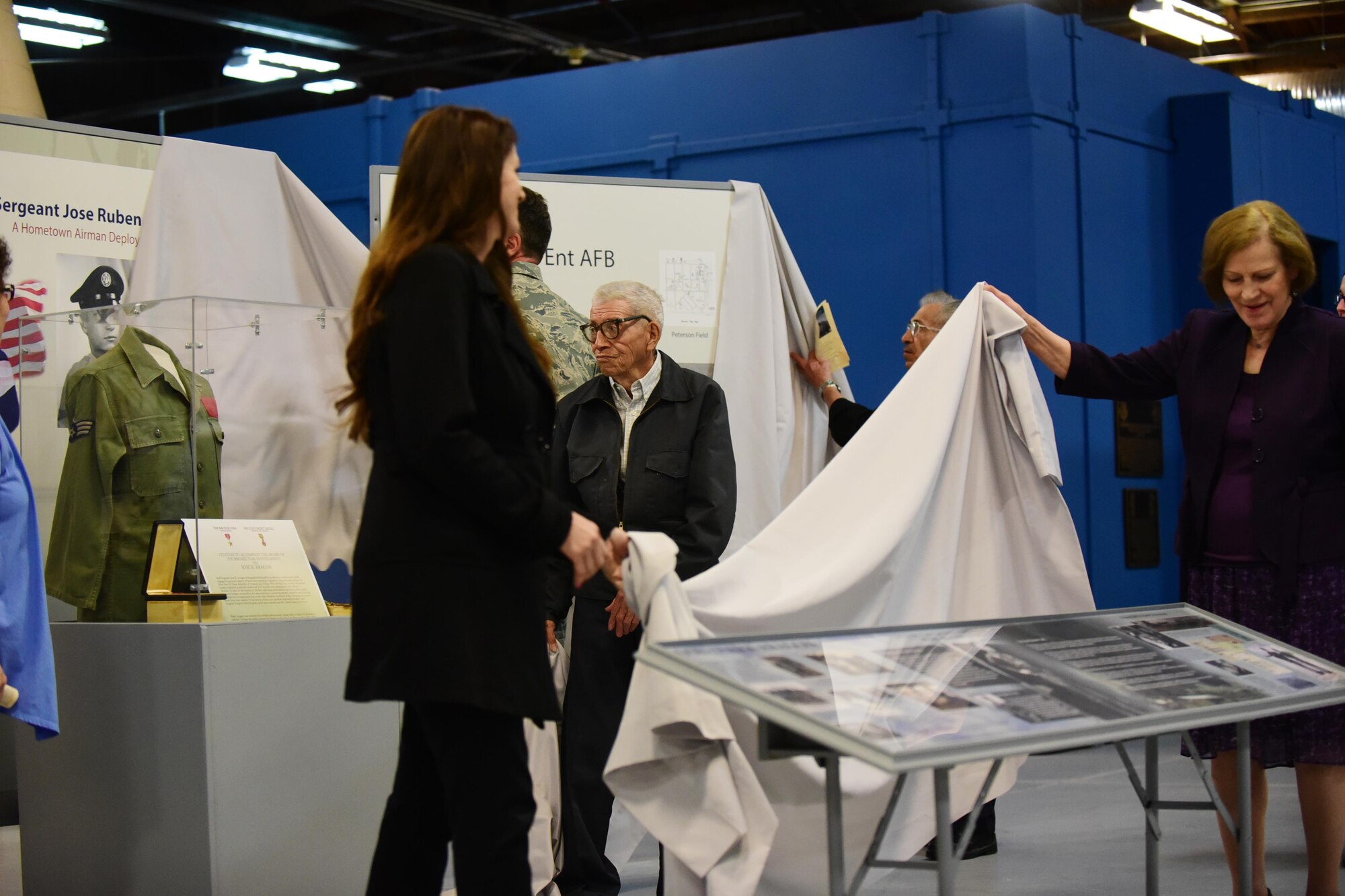 Members of Staff Sgt. Jose Aragon’s family unveil Peterson Air and Space Museum’s new exhibits honoring his service during the Vietnam War, May 16, 2016. An accident on Bien Hoa Air Base 50 years ago claimed the lives 27 Airmen including Aragon’s, who was posthumously awarded the Bronze Star for his actions that day. (U.S. Air Force photo by Staff Sgt. Amber Grimm)