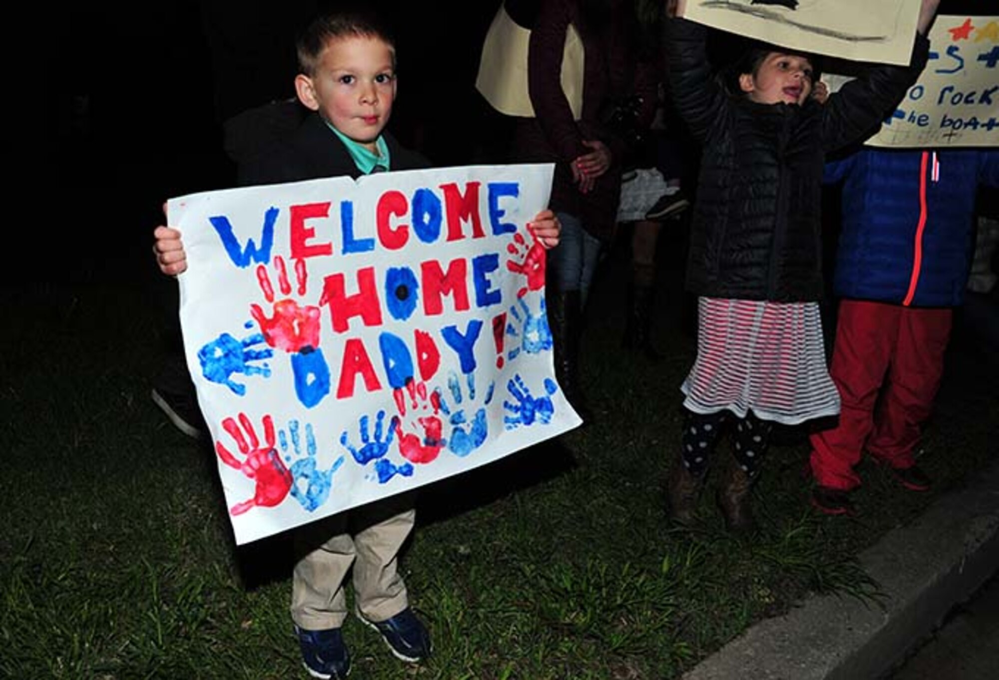 Air Force Reserve families await the arrival of their loved ones redeploying from Southwest Asia, May 4 at Joint Base McGuire-Dix-Lakehurst, New Jersey. 