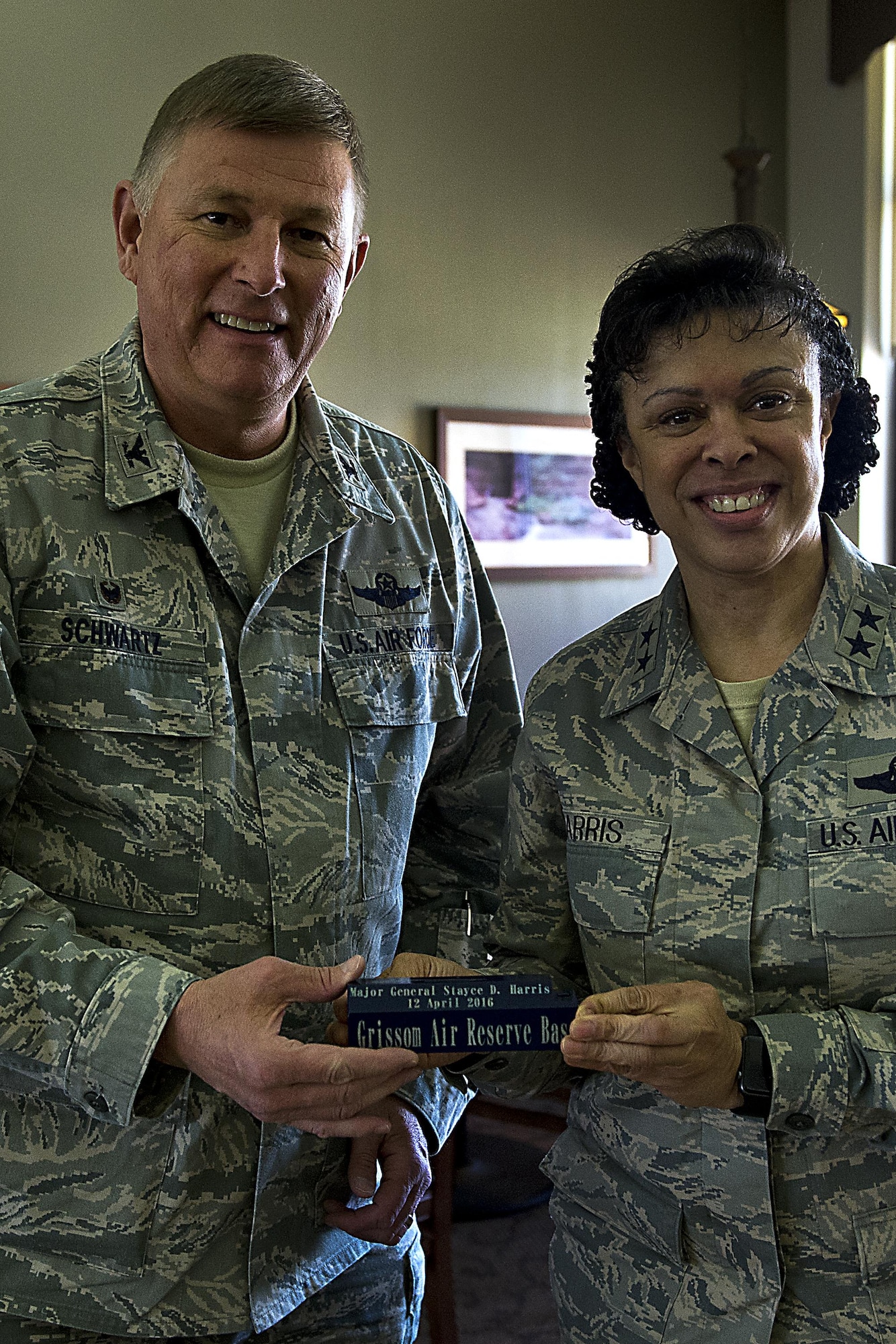 Maj. Gen. Stayce Harris, 22nd Air Force commander, presents Col. Doug Schwartz 434th Air Refueling Wing Commander with a signed chock to be displayed at Chocks April 12, 2016 at Grissom Air Reserve Base, Ind. Whenever a distinguished guest visits Grissom they are asked to sign a chock to be displayed at Chocks. (U.S. Air Force photo/Senior Airman Dakota Bergl)