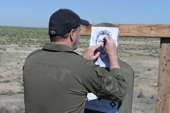 Scott Crupper, Caldwell police department officer, checks his target after firing April 20, 2016, at Mountain Home Air Force Base, Idaho. The officers were taught ways to make corrections to their weapon sights and techniques during long distance shots based on where they hit the target. (U.S. Air Force photo by Airman 1st Class Chester Mientkiewicz/Released)