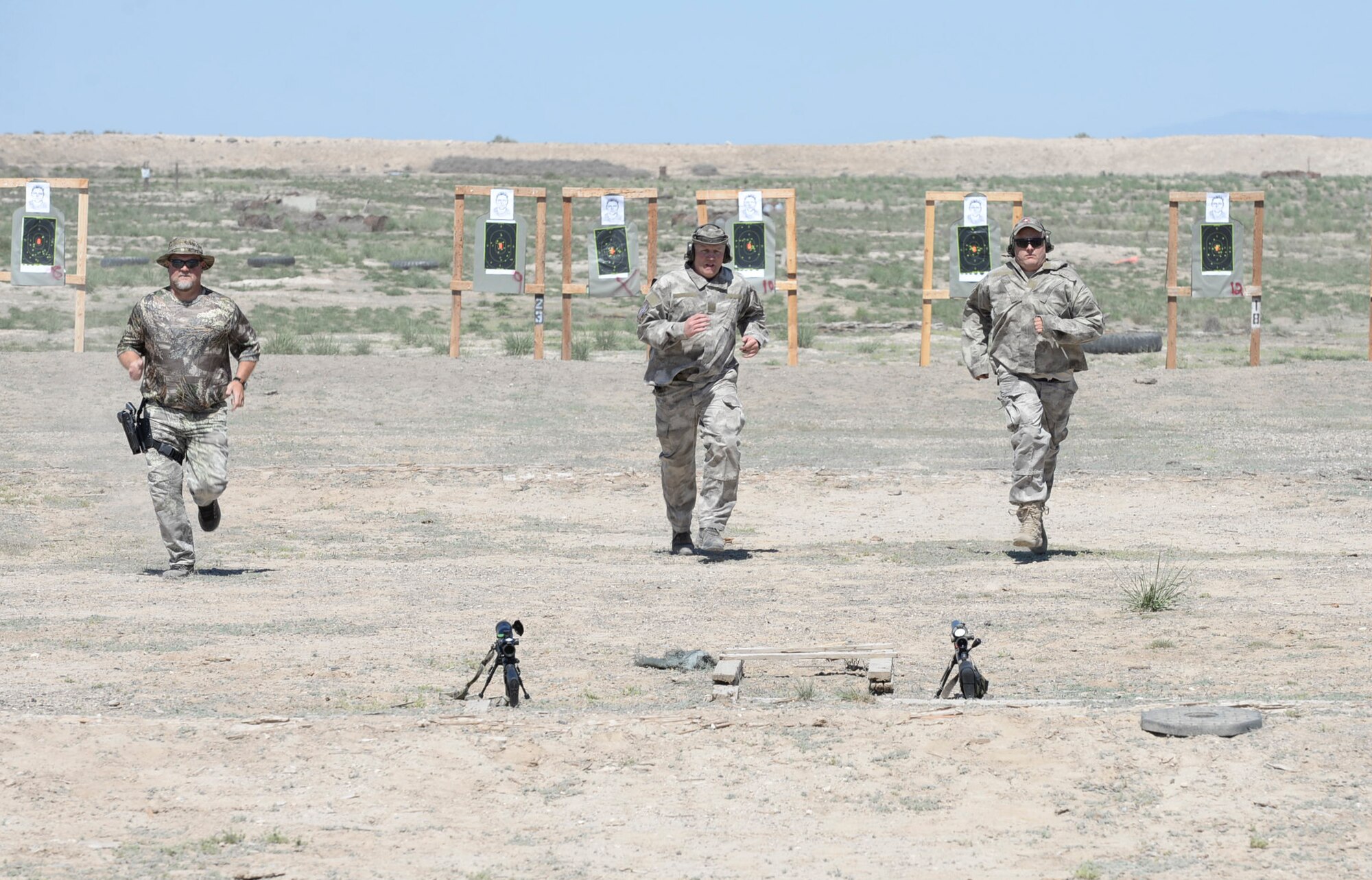 Local law enforcement officials run back to their weapons during a sniper training exercise April 20, 2016, at Mountain Home Air Force Base, Idaho. During this exercise the officers ran to their targets and then back to their weapons to fire in a limited amount of time to simulate the urgency of a real, life event. (U.S. Air Force photo by Airman 1st Class Chester Mientkiewicz/Released)