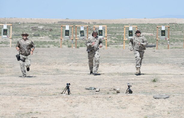 Local law enforcement officials run back to their weapons during a sniper training exercise April 20, 2016, at Mountain Home Air Force Base, Idaho. During this exercise the officers ran to their targets and then back to their weapons to fire in a limited amount of time to simulate the urgency of a real, life event. (U.S. Air Force photo by Airman 1st Class Chester Mientkiewicz/Released)