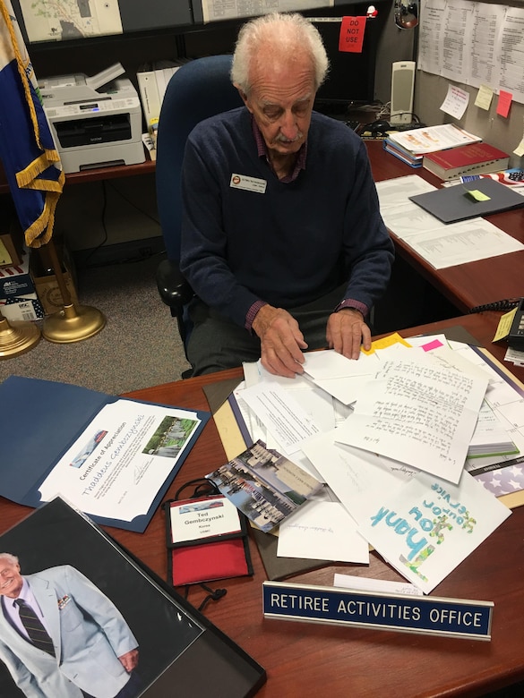 Ted Gambczynski, Peterson Air Force Base Retirees Activities Office director, looks through mementos from his Honor Flight of Southern Colorado experience April 21-23 in Washington, DC. He flew into the nation’s capital with 15 other Korean War veterans and 10 WWII veterans to tour historic memorials in honor of their military service. (U.S. Air Force photo by Dave Smith)
