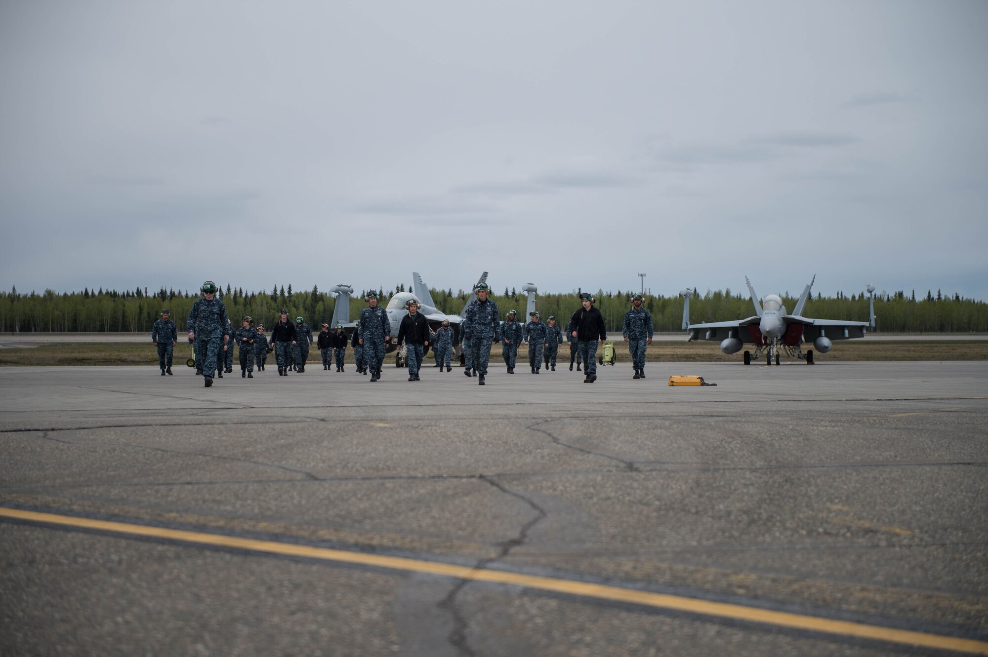 U.S. Navy Sailors from VAQ-137, Naval Air Station Whidbey Island, Washington, perform a foreign objects walk prior to a sortie May 9, 2016 during RED-FLAG-Alaska 16-1 at Eielson Air Force Base, Alaska. The Sailors walk their area of responsibility before each launch to provide safety to the pilots and prevent damage to aircraft engines. (U.S. Air Force photo by Staff Sgt. Shawn Nickel/Released)
