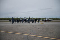 U.S. Navy Sailors from VAQ-137, Naval Air Station Whidbey Island, Washington, perform a foreign objects walk prior to a sortie May 9, 2016 during RED-FLAG-Alaska 16-1 at Eielson Air Force Base, Alaska. The Sailors walk their area of responsibility before each launch to provide safety to the pilots and prevent damage to aircraft engines. (U.S. Air Force photo by Staff Sgt. Shawn Nickel/Released)
