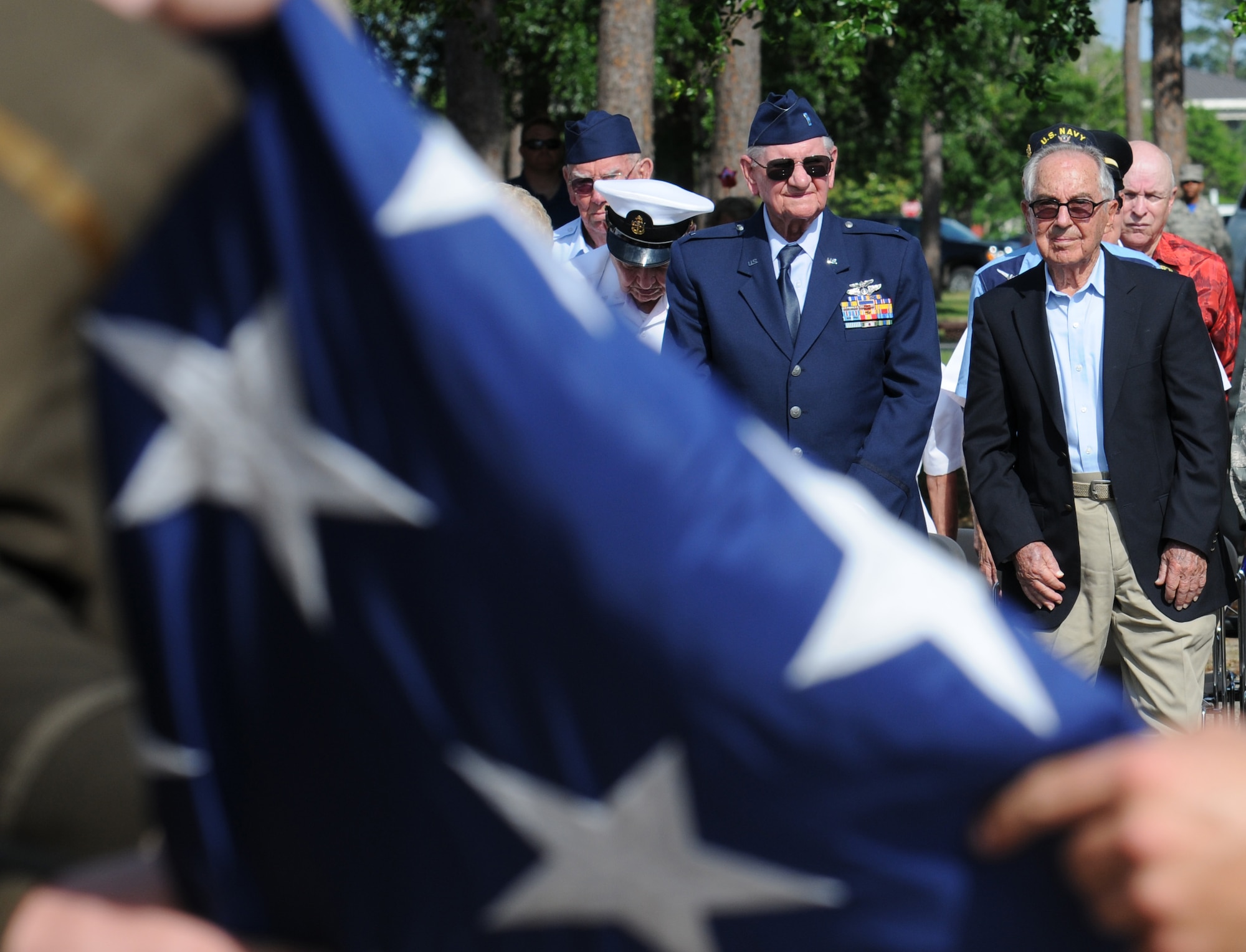 Chief Warrant Officer Thomas Adams, Jr., and Lt. Col. Henry Burkle, both retired and stationed at Keesler during WORLD WAR II, watch as members of the 81st Security Forces Squadron fold the U.S. flag during the Lt. Samuel Reeves Keesler, Jr. Memorial Retreat Ceremony May 13, 2016, Keesler Air Force Base, Miss. The event was held in honor of Lt. Keesler’s date of entry into the Army Air Service 99 years ago. The retreat ceremony is part of a year-long celebration of Lt. Keesler, a Mississippi native and WORLD WAR I hero, and the 75th anniversary of the opening of the base. (U.S. Air Force photo by Kemberly Groue)
