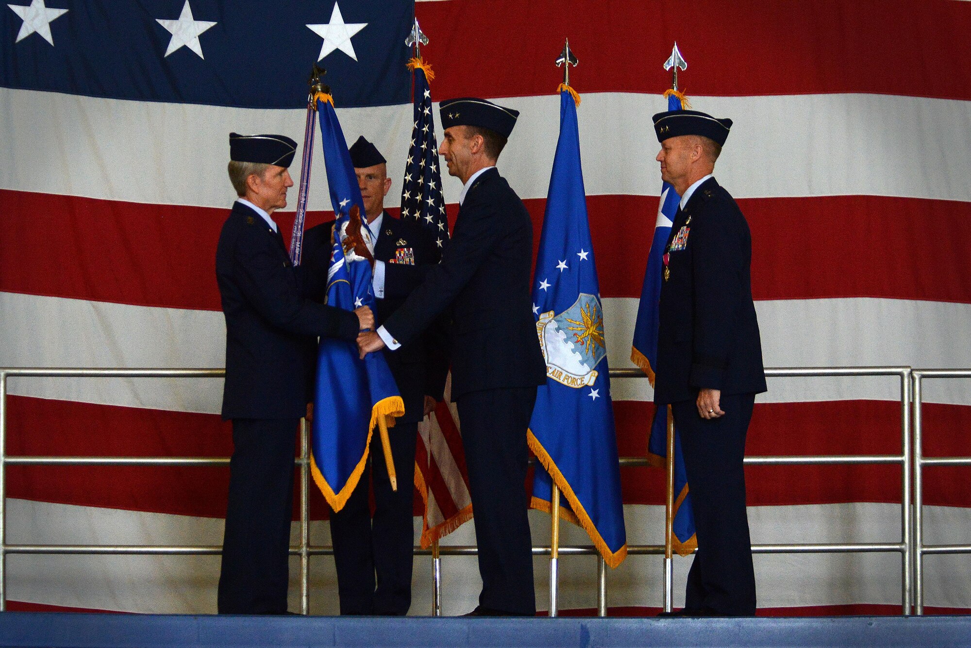 U.S. Air Force Gen. Hawk Carlisle, Air Combat Command commander, passes the Ninth Air Force guidon to Maj. Gen. Scott Zobrist, incoming Ninth Air Force commander, during a change of command ceremony at Shaw Air Force Base, S.C., May 17, 2016. The passing of the guidon is a time-honored tradition symbolizing the transfer of authority from the previous commander to the new commander. (U.S. Air Force photo by Airman 1st Class Kelsey Tucker)