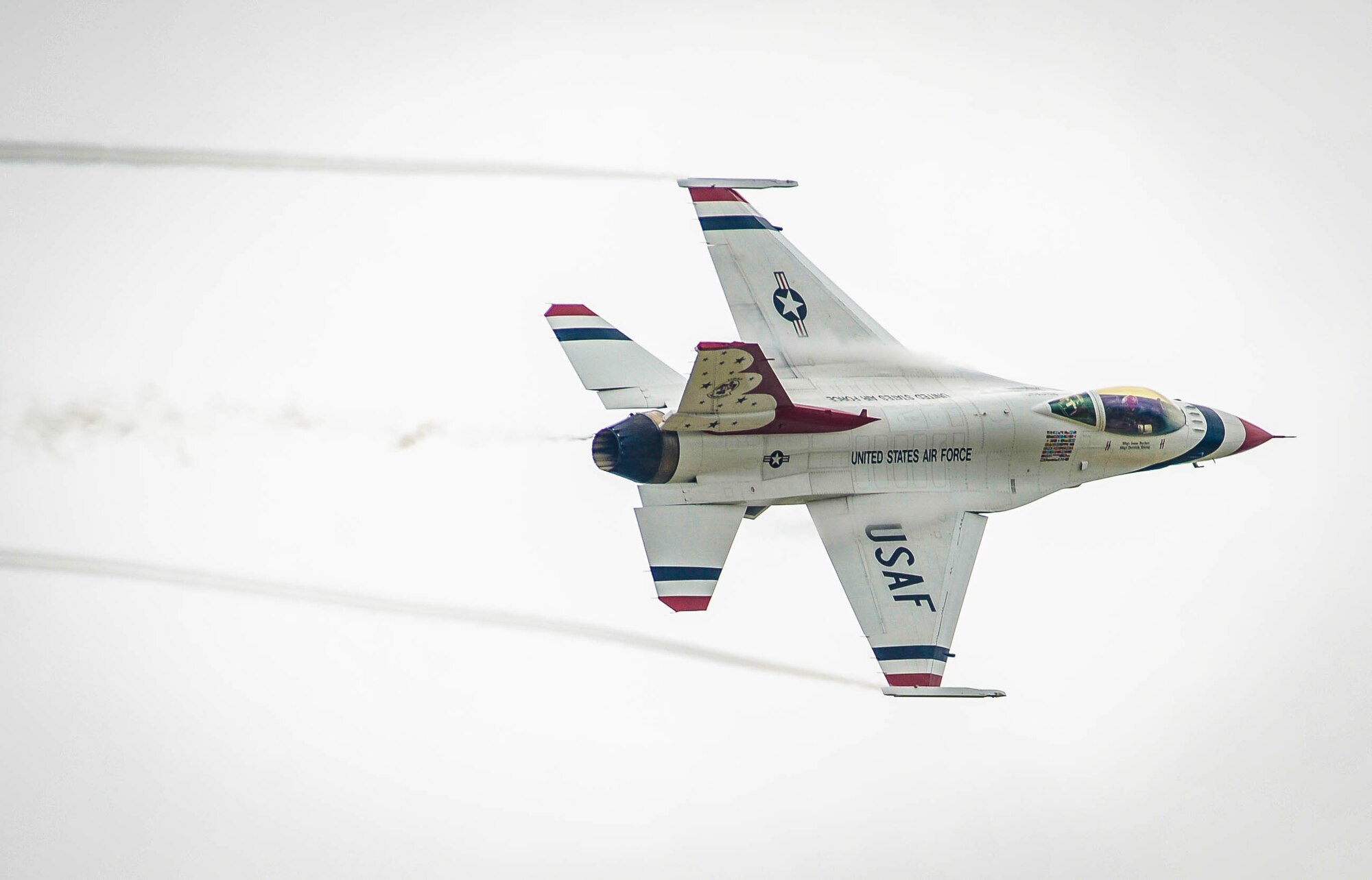 A member of the U.S. Air Force Precision Flying Demonstration Team – The Thunderbirds – flies over the flightline at Shaw Air Force Base, S.C., May 17, 2016. The Thunderbirds split up from their formation upon arrival to a new airfield in order to look for visual landmarks surrounding the base, which they use as distance markers during air shows. (U.S. Air Force photo by Senior Airman Jensen Stidham)