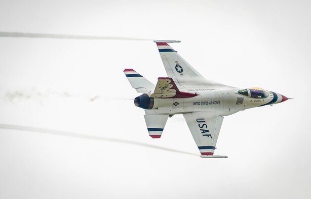 A member of the U.S. Air Force Precision Flying Demonstration Team – The Thunderbirds – flies over the flightline at Shaw Air Force Base, S.C., May 17, 2016. The Thunderbirds split up from their formation upon arrival to a new airfield in order to look for visual landmarks surrounding the base, which they use as distance markers during air shows. (U.S. Air Force photo by Senior Airman Jensen Stidham)