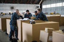 U.S. Navy Sailors from VAQ-137, Naval Air Station Whidbey Island, Washington, discuss upcoming maintenance prior to a sortie May 9, 2016 during RED-FLAG-Alaska (RF-A) 16-1 at Eielson Air Force Base, Alaska. RF-A is a Pacific Air Forces command directed field training exercise for U.S. and allied forces, to provide joint offensive counter-air, interdiction, close air support and large force employment training in a simulated combat environment. (U.S. Air Force photo by Staff Sgt. Shawn Nickel/Released)