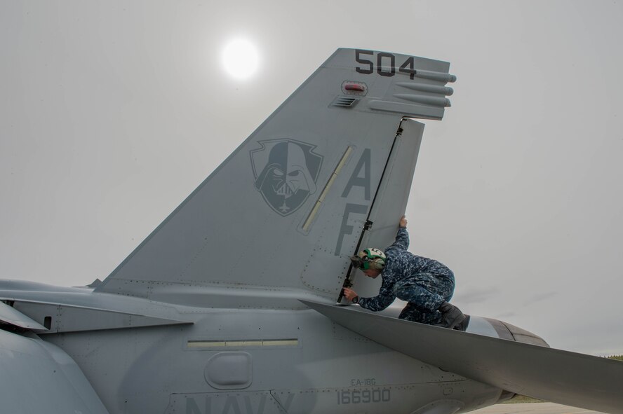 U.S. Navy Aviation Machinist Mate 2nd Class Joseph Neely, from VAQ-137, Naval Air Station Whidbey Island, Washington, inspects rivets and panels on an EA-18G Growler electronic attack aircraft prior to a sortie May 9, 2016 during RED-FLAG-Alaska (RF-A) 16-1 at Eielson Air Force Base, Alaska. The aircraft logged more than 500 tactical flying hours during RF-A 16-1, which requires maintainers to work around the clock. (U.S. Air Force photo by Staff Sgt. Shawn Nickel/Released)
