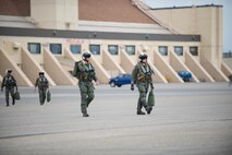 U.S. Navy pilots from VAQ-137, Naval Air Station Whidbey Island, Washington, transition to their EA-18G Growler aircraft for a sortie May 9, 2016 during RED-FLAG-Alaska (RF-A) 16-1 at Eielson Air Force Base, Alaska. The primary mission of the flying unit is the suppression of enemy air defenses in support of strike aircraft and ground troops by interrupting enemy electronic activity and obtaining tactical electronic intelligence. (U.S. Air Force photo by Staff Sgt. Shawn Nickel/Released)