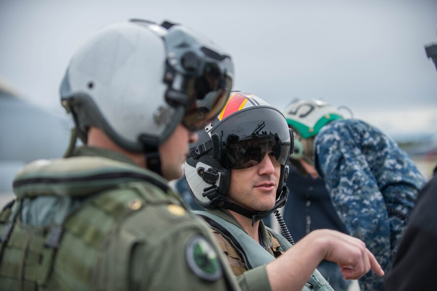 U.S. Navy pilots from VAQ-137, Naval Air Station Whidbey Island, Washington, speak to maintenance Sailors who keep the EA-18G Growler aircraft ready for sorties May 9, 2016 during RED-FLAG-Alaska (RF-A) 16-1 at Eielson Air Force Base, Alaska. Pilots and maintenance crews work together to address discrepancies and fulfill the unit’s mission. U.S. Air Force photo by Staff Sgt. Shawn Nickel/Released)
