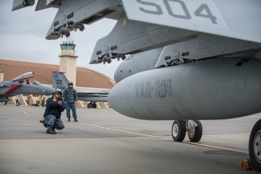 U.S. Navy Aviation Structural Mechanic 3rd Class Gabrial Rodriguez, from VAQ-137, Naval Air Station Whidbey Island, Washington, conducts pre-flight checks on an EA-18G Growler aircraft preparing for a sorties May 9, 2016 during RED-FLAG-Alaska (RF-A) 16-1 at Eielson Air Force Base, Alaska. Sorties for RF-A are flown in the Joint Pacific Alaska Range Complex, a more than 67,000 square mile area that provides a realistic training environment and allows commanders to train for full spectrum engagements, ranging from individual skills to complex, large-scale joint engagements. (U.S. Air Force photo by Staff Sgt. Shawn Nickel/Released)
