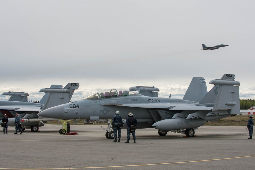 U.S. Navy Sailors from VAQ-137, Naval Air Station Whidbey Island, Washington, watch over an EA-18G Growler aircraft while other  May 9, 2016 during RED-FLAG-Alaska 16-1 at Eielson Air Force Base, Alaska. More than 40 Sailors from VAQ-137 are augmenting RF-A, a Pacific Air Forces command directed field training exercise for U.S. and allied forces, to provide joint offensive counter-air, interdiction, close air support and large force employment training in a simulated combat environment. (U.S. Air Force photo by Staff Sgt. Shawn Nickel/Released)
