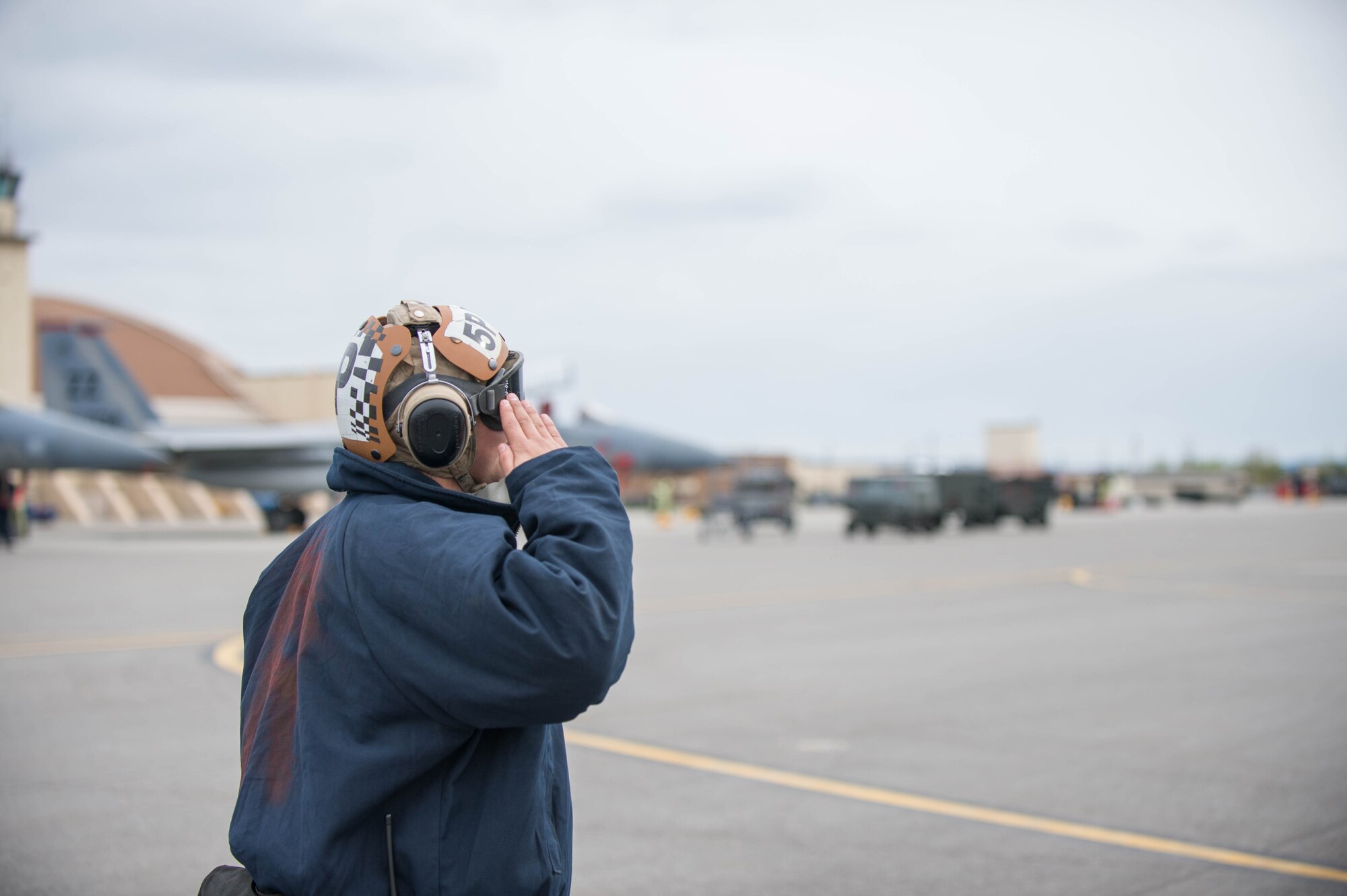 U.S. Navy Aviation Structural Mechanic 3rd Class Gabrial Rodriguez, from VAQ-137, Naval Air Station Whidbey Island, Washington, salutes an EA-18G Growler aircraft pilot preparing for a sortie May 9, 2016, during RED-FLAG-Alaska (RF-A) 16-1 at Eielson Air Force Base, Alaska. Sorties for RF-A are flown in the Joint Pacific Alaska Range Complex, a more than 67,000 square mile area that provides a realistic training environment and allows commanders to train for full spectrum engagements, ranging from individual skills to complex, large-scale joint engagements. (U.S. Air Force photo by Staff Sgt. Shawn Nickel/Released)
