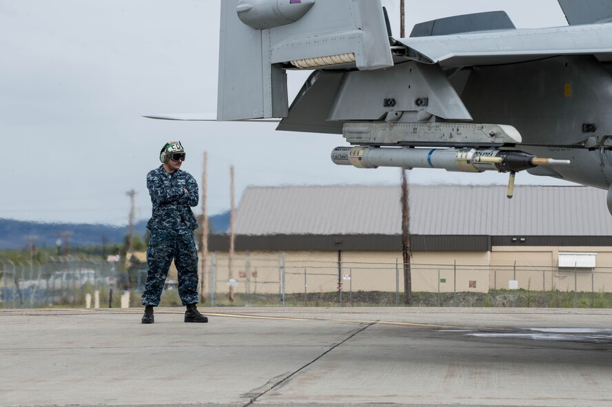 U.S. Navy Aviation Machinist Mate 2nd Class Joseph Neely, from VAQ-137, Naval Air Station Whidbey Island, Washington, stands in the jet wash of an EA-18G Growler aircraft while preparing it for a sortie May 9, 2016, during RED-FLAG-Alaska (RF-A) 16-1 at Eielson Air Force Base, Alaska. The aircraft logged more than 500 tactical flying hours during RF-A 16-1, which requires maintainers to work around the clock. (U.S. Air Force photo by Staff Sgt. Shawn Nickel/Released)
