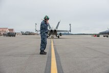 Aviation Electronic Technician Chief Christopher Fink, from VAQ-137, Naval Air Station Whidbey Island, Washington, stands in the jet wash of an EA-18G Growler aircraft after supervising the launch of two jets for a sortie May 9, 2016, during RED-FLAG-Alaska (RF-A) 16-1 at Eielson Air Force Base, Alaska. The aircraft logged more than 500 tactical flying hours during RF-A 16-1, which requires maintainers to work around the clock. (U.S. Air Force photo by Staff Sgt. Shawn Nickel/Released)
