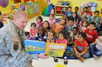 Sgt. Russell Toof, a public affairs specialist assigned to the U.S. Army Reserve's 326th Mobile Public Affairs Detachment in Reading, Pennsylvania, reads to children at a preschool in Clementon, New Jersey May 12 as part of a military appreciation day at the school.