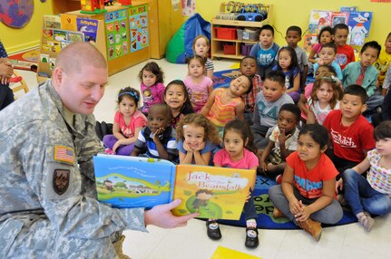 Sgt. Russell Toof, a public affairs specialist assigned to the U.S. Army Reserve's 326th Mobile Public Affairs Detachment in Reading, Pennsylvania, reads to children at a preschool in Clementon, New Jersey May 12 as part of a military appreciation day at the school.