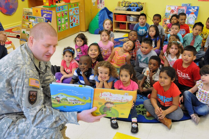 Sgt. Russell Toof, a public affairs specialist assigned to the U.S. Army Reserve's 326th Mobile Public Affairs Detachment in Reading, Pennsylvania, reads to children at a preschool in Clementon, New Jersey May 12 as part of a military appreciation day at the school.
