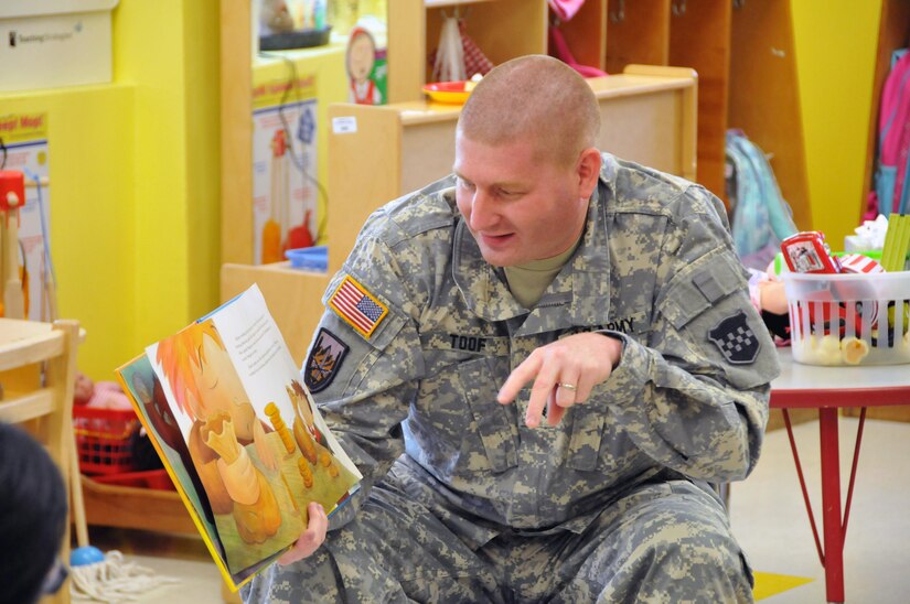 Sgt. Russell Toof, a public affairs specialist assigned to the U.S. Army Reserve's 326th Mobile Public Affairs Detachment in Reading, Pennsylvania, reads to children at a preschool in Clementon, New Jersey May 12 as part of a military appreciation day at the school.