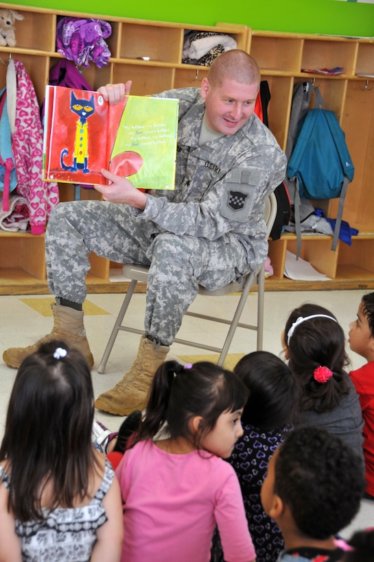 Sgt. Russell Toof, a public affairs specialist assigned to the U.S. Army Reserve's 326th Mobile Public Affairs Detachment in Reading, Pennsylvania, reads to children at a preschool in Clementon, New Jersey May 12 as part of a military appreciation day at the school.