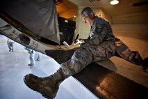 Tech. Sgt. Paul Carissimo, 932nd Maintenance Squadron, looks over the list of areas to inspect during a routine inspection of a C-40c cargo/luggage bay May 2, 2016, Scott Air Force Base, Illinois.  (U.S. Air Force photo by Christopher Parr)