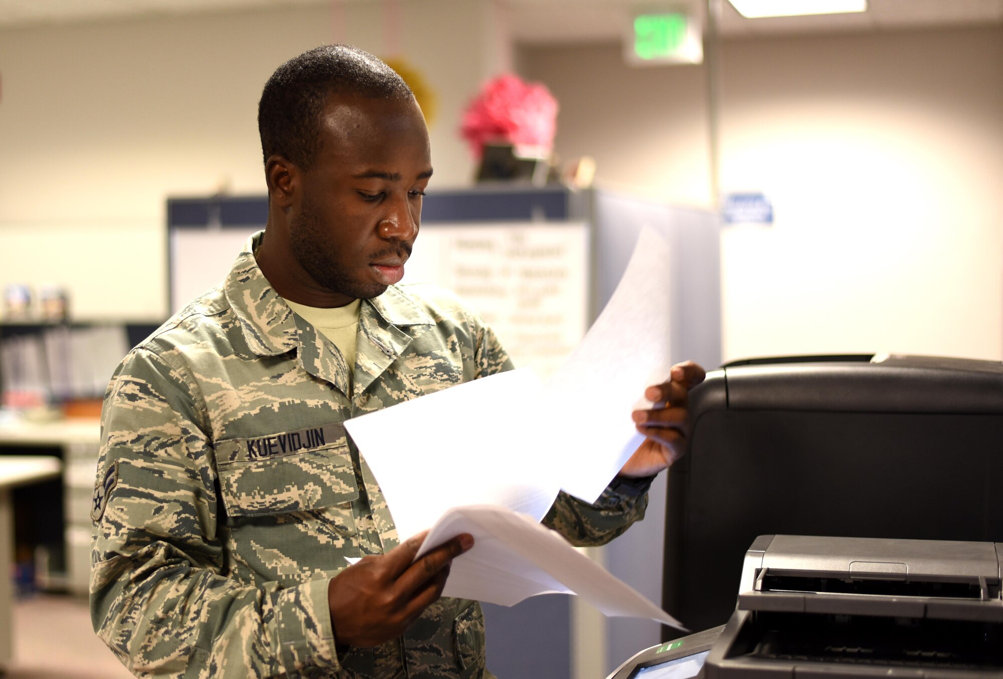Airman 1st Class Folly Kuevidjin, a 21st Comptroller Squadron financial management specialist, scans and sends financial documents at Peterson Air Force Base, Colo., on May 17, 2016. Kuevidjin was tasked to support Operation Juniper Micron at the 768th Expeditionary Air Base Squadron in Niamey, Niger, as the main translator for the base, on call 24/7. (U.S. Air Force photo by Airman 1st Class Dennis Hoffman)