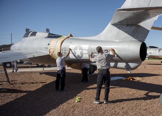 From left to right: Jesse and Mike, M1 Support Systems aircraft corrosion specialists at Holloman Air Force Base N.M., apply decals to an F-84F Thunderstreak after sanding and re-painting it at Heritage Park here May 16. The F-84F Thunderstreak was used by Strategic Air Command, Tactical Air Command, the Air National Guard and NATO Air Forces during the Korean War. (Last names are being withheld do to operational requirements) (U.S. Air Force photo by Airman 1st Class Randahl J. Jenson)    