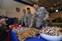 Schriever Airmen grab snacks and giveaways during the Wingman University pep rally at Schriever Air Force Base, Colorado, Thursday, May 12, 2016. Students were able to take their snacks and supplies with them throughout the day to all of their classes and activities. (U.S. Air Force photo/2nd Lt. Darren Domingo)