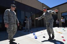 Senior Airman Nicholas Rogers, 50th Contracting Squadron, guides 1st Lt. Blake Ishmael, through a team building exercise during Wingman University at Schriever Air Force Base, Colorado, Thursday, May 12, 2016. Students were able to come together from different units and engage in classes that focused on Airmen resiliency, skill building, peer-to-peer cohesion and unit wellness. (U.S. Air Force photo/2nd Lt. Darren Domingo)
