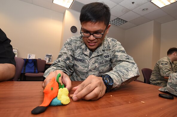 Airman 1st Class Jacob Ordonez molds Play-Doh during a Wingman University team building class at Schriever Air Force Base, Colorado, Thursday, May 12, 2016. Students attended a pep rally to start the day along with three classes of their choice during the base-wide event. (U.S. Air Force photo/2nd Lt. Darren Domingo)