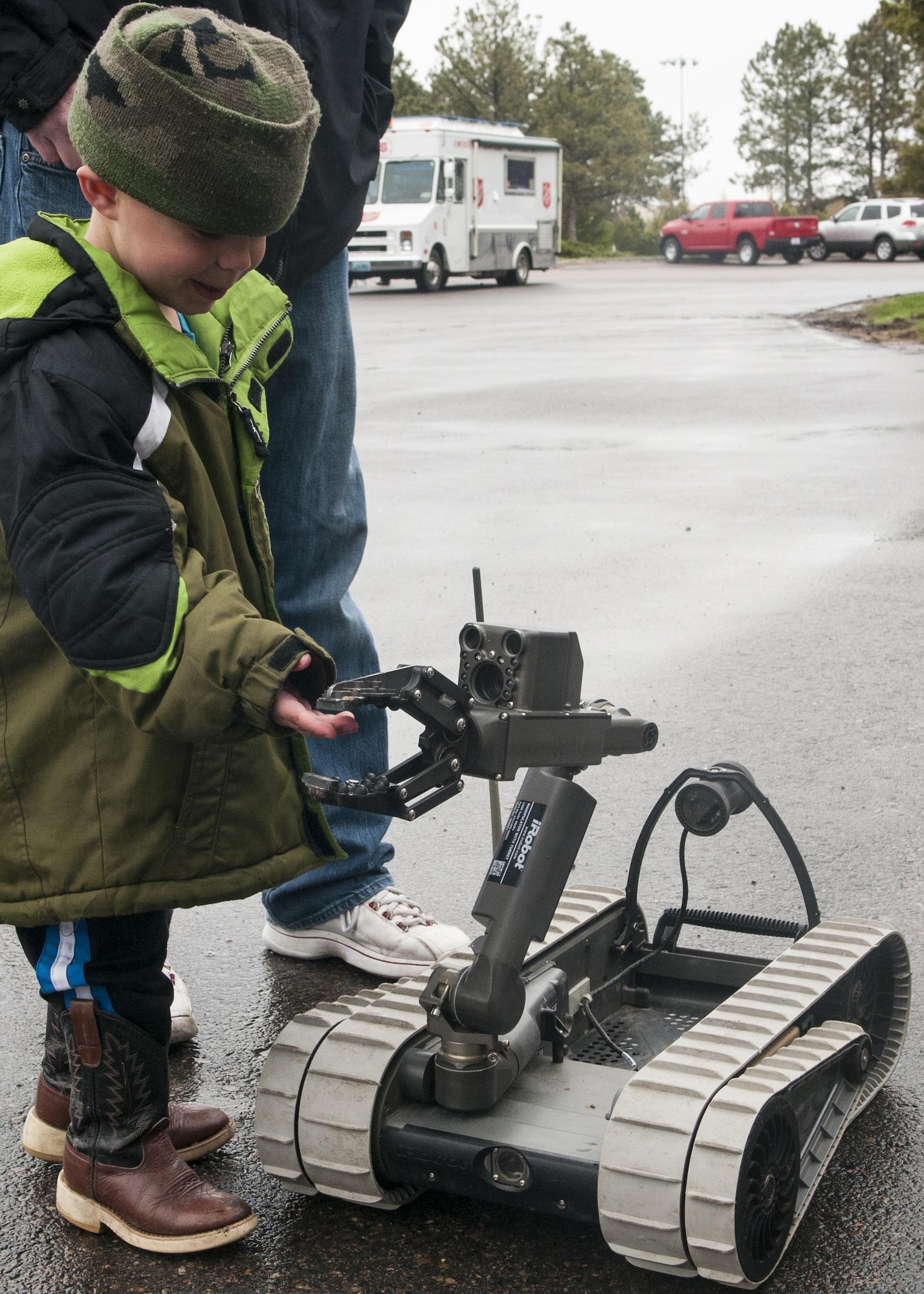 Chase Koenings, 4, greets the 90th Civil Engineers Explosive Ordnance Disposal Pacbot 310, during the city’s annual Armed Forces Day celebration at the Cheyenne, Wyo., Veterans Administration Medical Center May 14, 2016. EOD manned the robot’s controls, showing off the unit’s capabilities. (U.S. Air Force photo by Airman 1st Class Malcolm Mayfield)