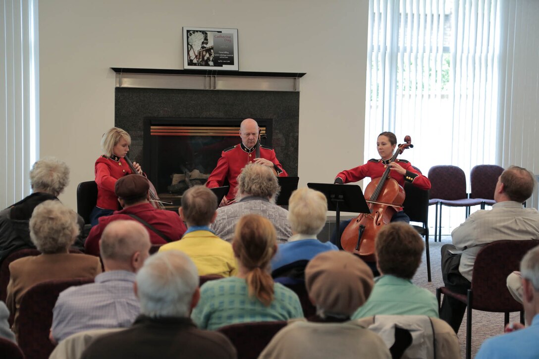 On May 15, 2016, the Marine Band presented a concert titled “Picture Studies” at the Rachel M. Schlesinger Concert Hall and Arts Center in Alexandria, Va. Prior to the concert, a cello trio provided pre-concert music in the lobby. (U.S. Marine Corps photo by Staff Sgt. Rachel Ghadiali/released)