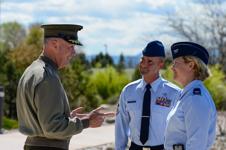 Gen. Joseph Dunford, Chairman of the Joint Chiefs of Staff, speaks with Chief Master Sgt. John Bentivegna, 50 SW command chief, and Col. DeAnna Burt, 50th Space Wing commander, following a visit to the Joint Interagency Combined Space Operations Center at Schriever Air Force Base, Colorado, Friday, May 13, 2016. The center provides the Department of Defense and the intelligence community with a robust test and experimentation environment to better integrate space operations in response to threats and afford unity of effort between diverse space communities. (U.S. Air Force photo/Christopher DeWitt)